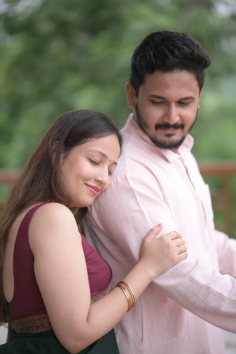 Dr. Apoorva in a wine blouse, holding Dr. Saurabh's arm