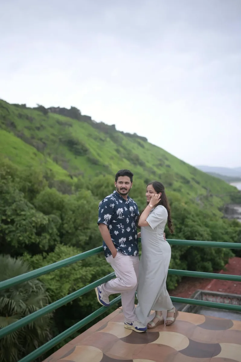 The couple at a green hillside viewpoint